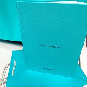 Tiffany & Co. Brand new, “This is a Tiffany Ring” book. Classic blue col…